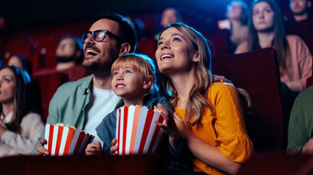 Family at cinema with popcorn